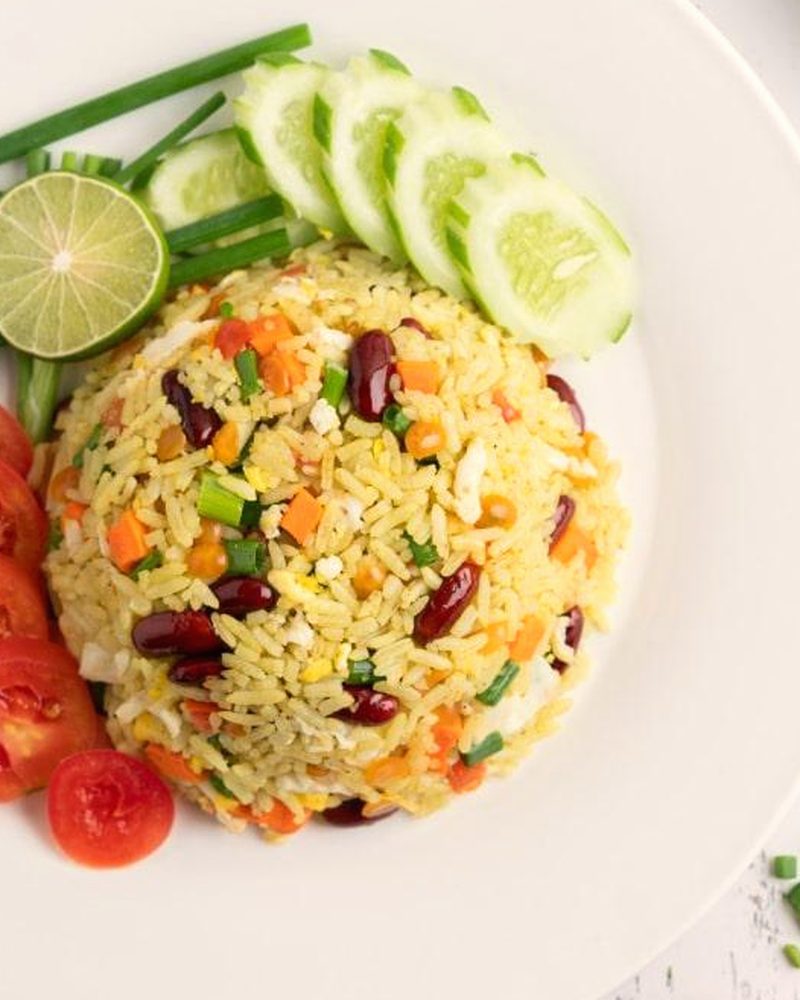A plate of Nigerian fried rice with vegetables