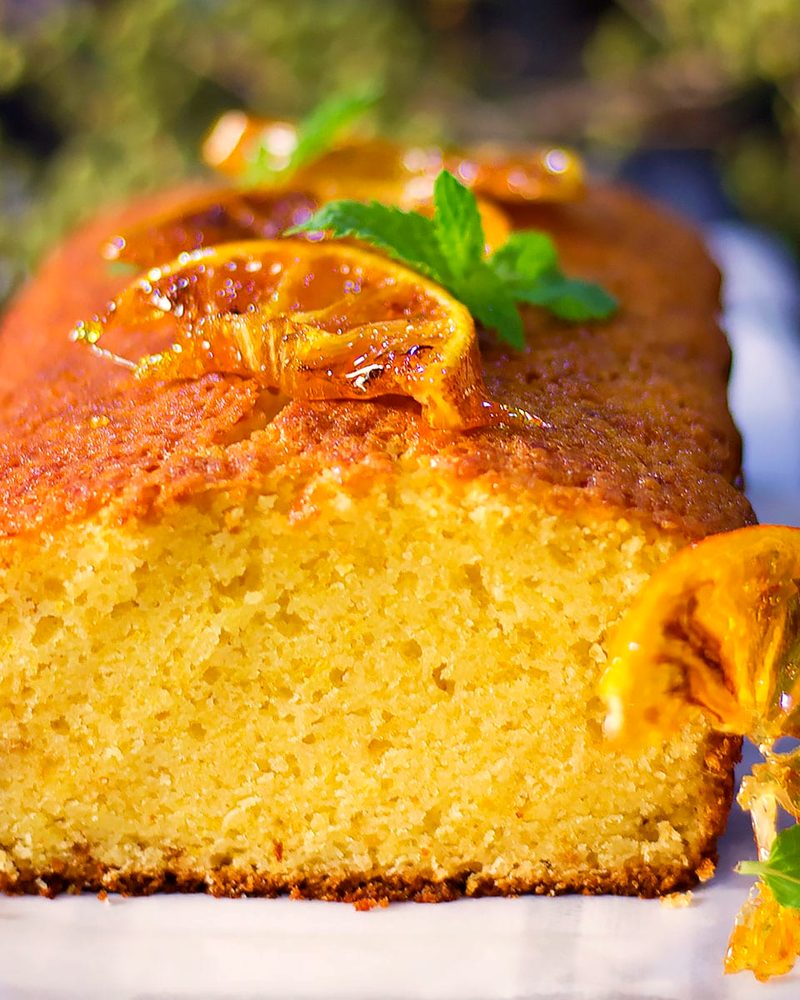An orange loaf cake topped with candied orange slices